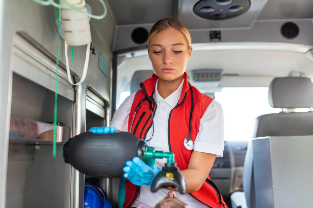 A woman in an ambulance holds a gas mask, ready for emergency response in a critical situation - Webco Marketing Blogs