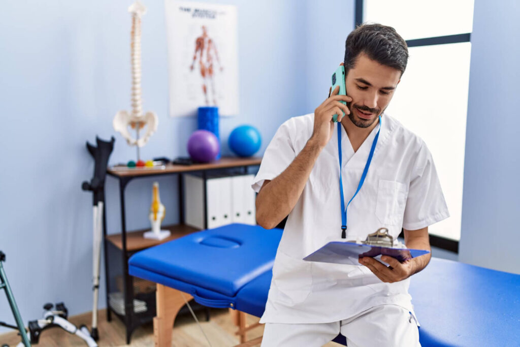 Click to call ads for physiotherapists a therapists is engaged in a conversation on his cell phone